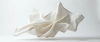 Crumpled white fabric with soft folds and flowing waves against neutral background, suitable for textile design, fashion concepts, and abstract compositions.
