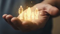 Glowing family silhouettes floating above protective cupped hands with magical light effects symbolizing care, security and family protection concept.