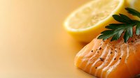 Fresh salmon fillet with lemon slice and herb garnish on warm background. Suitable for food photography, culinary blogs, restaurant menus, and healthy eating content.