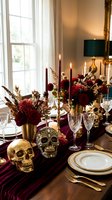 Elegant Halloween dinner table setting with burgundy flowers, golden skulls, lit candles and crystal glasses for autumn entertaining and holiday decor.