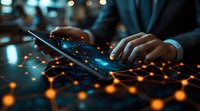 Person typing on laptop keyboard with glowing orange and blue network connections overlay, dark moody lighting creates futuristic cybersecurity atmosphere.