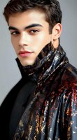 Young male model wearing luxurious black jacket with shimmering copper and gold pattern, dramatic side lighting highlights defined features and glowing skin.