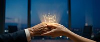 Business hands holding glowing light bulb with innovation concept against city skyline at dusk for creative solutions and teamwork collaboration.