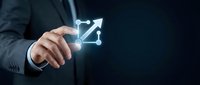 Businessman touching glowing growth arrow icon on dark background representing business success, progress and upward trend in corporate environment.