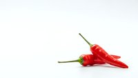Fresh red chili peppers isolated on white background for culinary and cooking projects.