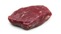 Fresh raw beef steak isolated on white background. Premium cut of red meat showing marbling and texture, ready for cooking or commercial food photography.