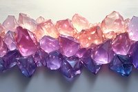Luminous crystal formations in pink, purple and blue hues arranged in horizontal composition with dramatic lighting creating ethereal glow and reflections.