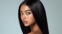 Young Asian woman with flawless skin and long straight black hair against light blue background, showcasing natural beauty for cosmetic advertising.