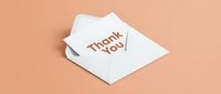 White envelope with a thank you card on a pastel peach background, perfect for greeting, appreciation, and gratitude concepts in stationery design.