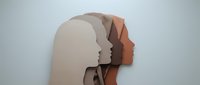 Paper cut silhouettes of human heads in profile showing mental health layers and psychological depth for therapy and wellness concepts.