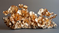 Elegant golden floral sculpture with metallic blooms arranged on a textured base, showcasing luxurious craftsmanship for upscale interior decor.