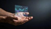 Male hand holding holographic financial data display with stock charts and market graphs for business analytics and investment concepts.
