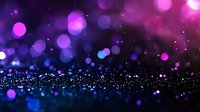 Magical purple and blue bokeh lights scattered on dark background with glowing particles and dreamy defocused spots create atmospheric festive mood.
