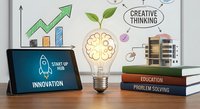 Glowing light bulb with brain and plant, tablet showing startup hub, books, and growth chart on whiteboard for business innovation concept.