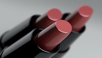 Luxurious red lipsticks arranged in elegant composition with dramatic lighting and soft shadows creating sophisticated cosmetic still life for beauty advertising.