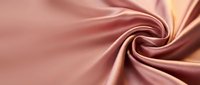 Luxurious rose gold silk fabric with elegant swirled texture for fashion design, wedding decor, and premium textile projects.