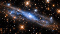 Glowing blue spiral galaxy surrounded by bright orange stars in deep space, cosmic nebula with stardust and stellar formations against dark background.