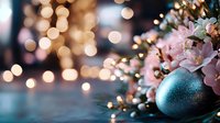 Festive holiday arrangement with turquoise ornament, pink flowers and warm bokeh lights creating magical Christmas atmosphere for seasonal celebrations.