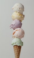 Towering ice cream cone with five colorful scoops stacked high in waffle cone on neutral background for dessert and summer treat concepts.