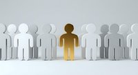Golden figure standing out among white and gray crowd representing leadership, uniqueness, and individual success in business teamwork concept.