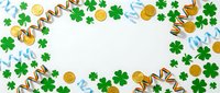 St. Patrick's Day festive frame with green shamrocks, gold coins and ribbons on white background. Holiday celebration border design for greeting cards.
