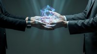 Two businessmen in formal suits hold a glowing holographic crystal between their hands, symbolizing innovation, technology partnership, and digital transformation in corporate environment.