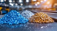Colorful plastic polymer granules in piles of blue, silver, and golden colors on industrial manufacturing surface with blurred background, raw material for production.