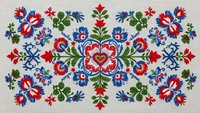 Traditional folk art embroidery pattern with colorful floral motifs in red, blue and green on beige background for textile design and cultural decoration.