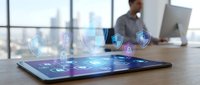 Tablet displaying digital security interface with holographic lock icons and data protection symbols, businessman working in modern office with city skyline, cybersecurity and technology concept.