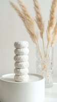 Zen stone tower on white surface with pampas grass creating peaceful spa atmosphere for meditation and wellness practices.