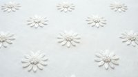 White embossed daisy flowers pattern on textured paper background. Seamless repeating floral design for wallpaper, scrapbooking and craft projects.