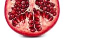Fresh ripe pomegranate half showing ruby red arils and seeds on white background. Healthy organic superfruit for nutrition and wellness concepts.