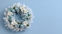 Festive winter wreath with white poinsettias, blue berries, and frosted pine branches on light blue background, perfect for holiday decor.