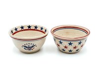 Pair of ceramic mixing bowls with patriotic star motifs and red trim, featuring cream-colored glaze. Isolated on white background, ready for design projects, product mockups, and kitchenware compositions.