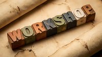 Workshop spelled out in vintage wooden letterpress blocks on aged paper background for creative typography and crafting projects.