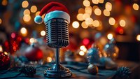 Vintage microphone wearing Santa hat against blurred Christmas lights and decorations, creating festive holiday atmosphere with warm bokeh background.