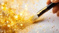 Magical gold glitter dust scattered by artist brush on light background with bokeh effect and sparkles creates festive atmosphere.