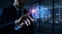 Professional businessman touching glowing cloud computing hologram with digital icons in modern office environment representing data storage technology.
