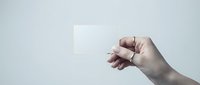 Hand holding blank white card against light background for business presentation mockup design template branding identity corporate communication.