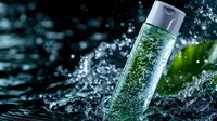 Refreshing sparkling water bottle with bubbles and splash effects against dark background with green leaves for beverage advertising and healthy lifestyle concepts.