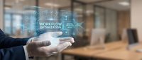 Business professional holding holographic workflow optimization interface with digital icons in modern office environment for corporate technology presentations.