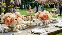 Elegant outdoor wedding reception table with peach and cream rose centerpieces, tiered dessert stands, and formal place settings in blooming garden venue.