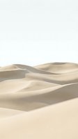 Smooth sand dunes with undulating waves and soft shadows against clear sky, isolated on white background for design use.
