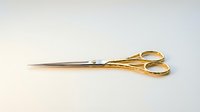 Elegant gold-plated sewing scissors with sharp stainless steel blades isolated on white background, ready for crafting, tailoring, and design projects.