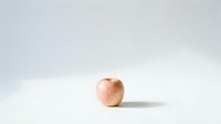 Single fresh red apple on clean white background with soft shadow for healthy eating and nutrition concepts.