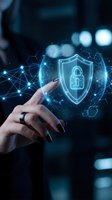 Hand touching holographic cybersecurity shield with padlock icon and network connections for data protection and digital security concepts.