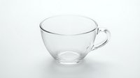 Clear glass tea cup with handle isolated on white background for kitchen and dining design projects.