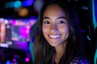 Young Asian woman smiling at night with colorful neon lights and bokeh in background, radiating happiness and joy in urban nightlife setting.