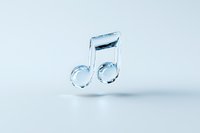 Musical note made of clear ice or glass floating against light blue background with soft shadow, minimalist artistic composition for creative design projects.