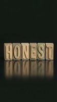 Wooden letter blocks spelling HONEST on dark reflective surface with dramatic lighting for business ethics and integrity concepts.